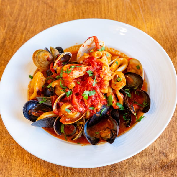 San Vito's seafood pasta with mussels, clams, and calamari in a rich red sauce.